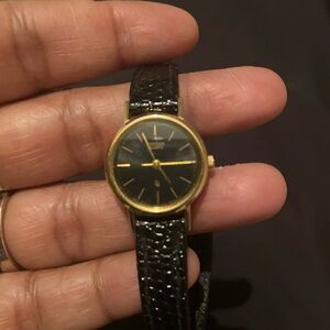 Vintage Timex Classic Black and Gold Timepiece